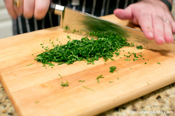 Preparing the parsley for finishing the snapper