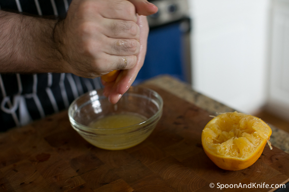 Hand squeezing the oranges for flounder ceviche