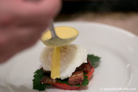 Pouring the Hollandaise sauce over the top