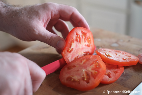 Cutting thick slices of tomato for the BLT base